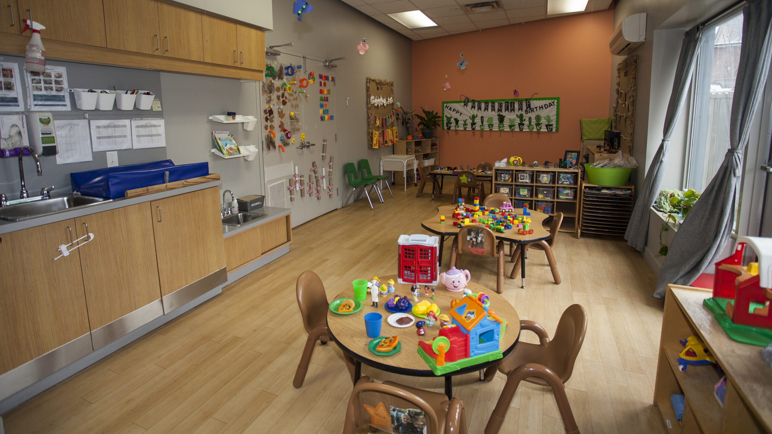toddler room with toys and tables
