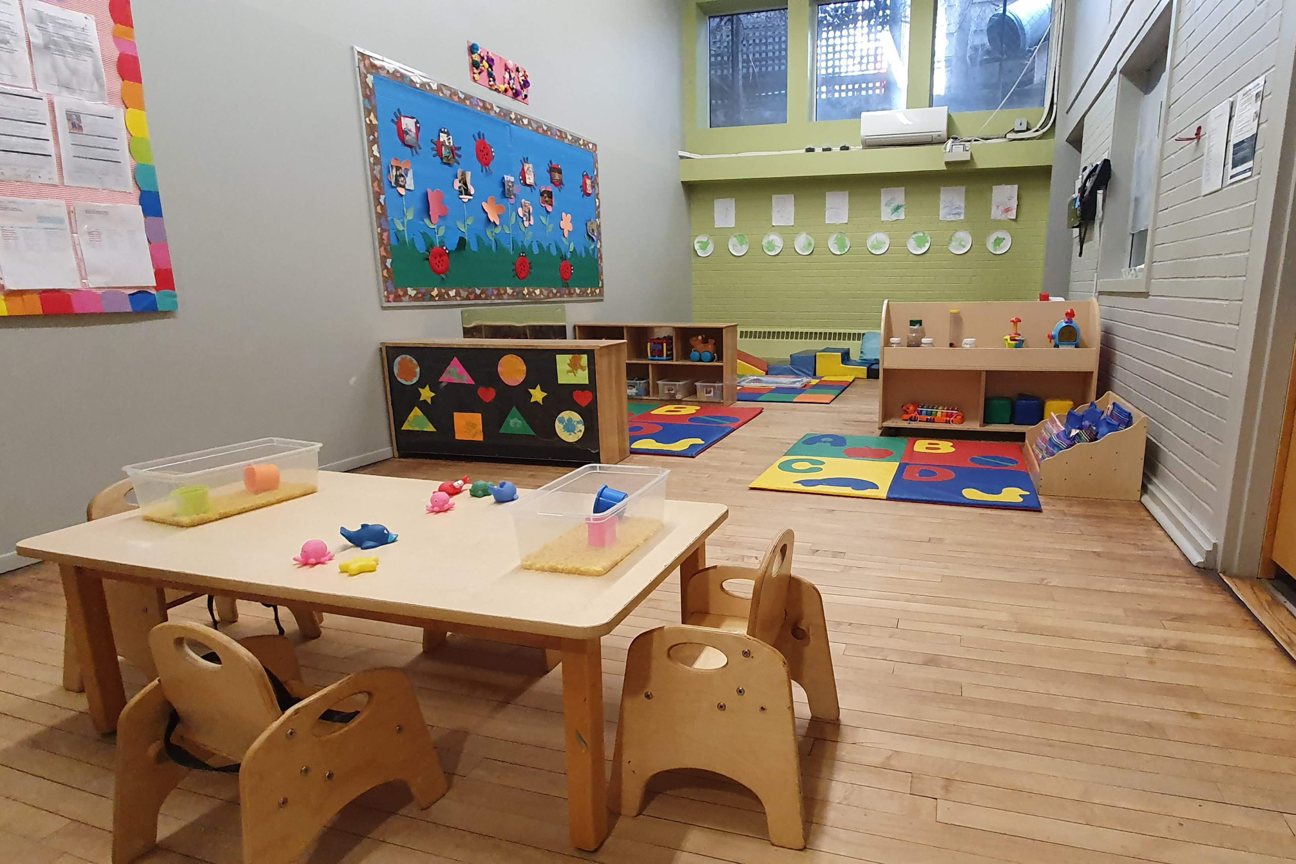 infant room with table and play area